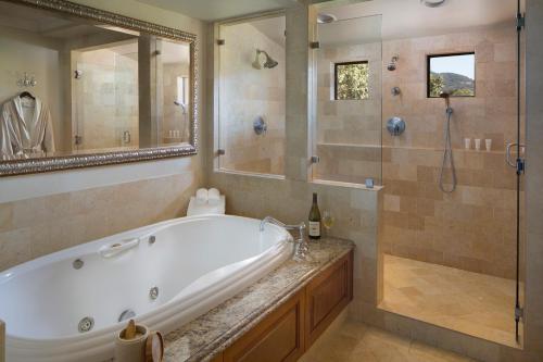 a large bathroom with a tub and a shower at Napa Valley Lodge in Yountville