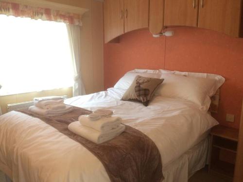 a bedroom with a bed with towels on it at Heaste Retreat in Broadford