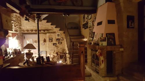 a living room with a fireplace and a stone wall at Carmen De Arnas in Colungo