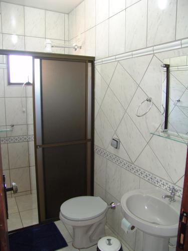 a bathroom with a toilet and a sink at Pousada Don Blu in Itaipulandia