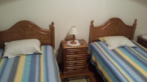 two beds sitting next to each other in a bedroom at Hospedaria D. Fernando in Viseu