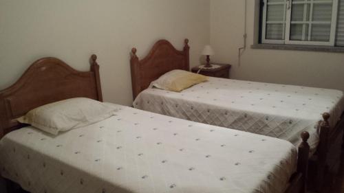 two beds sitting next to each other in a bedroom at Hospedaria D. Fernando in Viseu