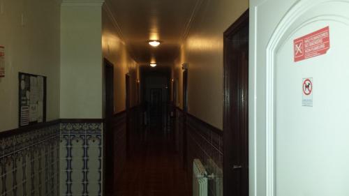 a hallway of a building with a staircase and a hallwayngthbestosbestosbestosbestos at Hospedaria D. Fernando in Viseu