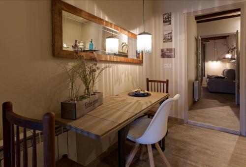 a dining room with a table and two chairs at El Jardinet de Sant Esteve in Olot