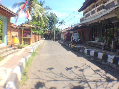 an empty street in a town with buildings at Taman Lily's Hotel in Lovina