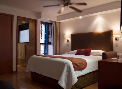 a bedroom with a large bed and a window at Hotel Gillow in Mexico City