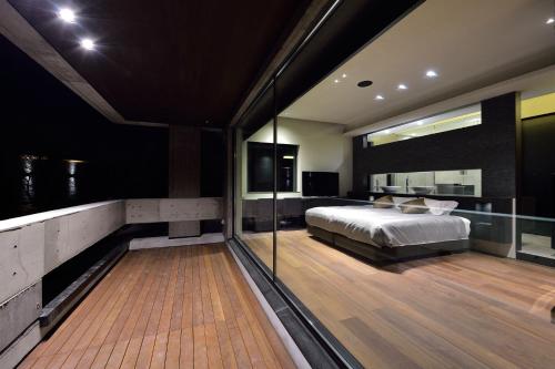 a bedroom with a bed and a balcony at Ori in Niseko