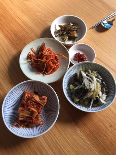 a group of plates of food on a table at Guest House Dalggume in Mokpo