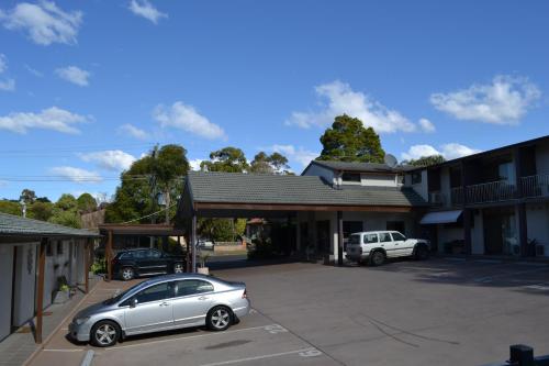 a car parked in a parking lot in front of a building at Parkhaven in Nowra