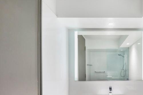 a mirror over a sink in a bathroom at Novotel Sydney City Centre in Sydney