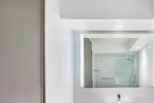 a bathroom with a sink, mirror, and bathtub at Mercure Sydney Wynyard in Sydney