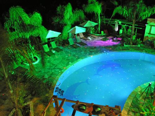 a swimming pool at night with green lights at Filoxenia Sea View in Parga