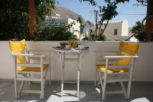 a table and chairs sitting on a patio at Villa Markos in Perissa
