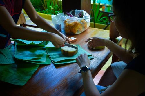 a group of people sitting at a table eating food at Hongkhao Village in Chiang Mai