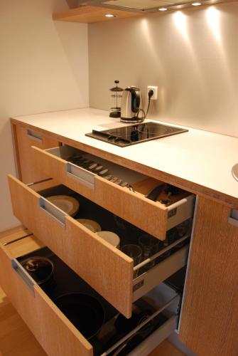 a kitchen with a counter with drawers and a stove at KURESSAARE TALLINN STREET APARTMENTs in Kuressaare