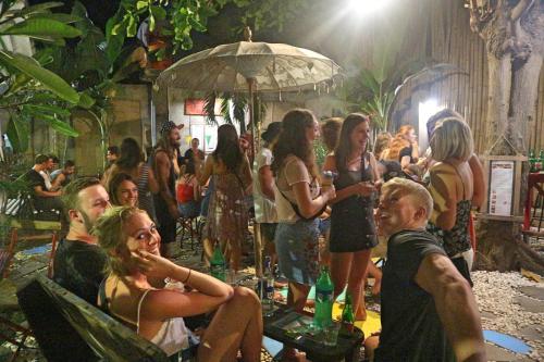a group of people standing around in a crowd at Gili La Boheme in Gili Trawangan