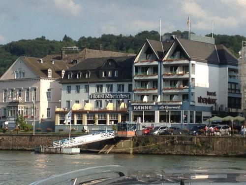 a group of buildings next to a body of water at Hotel Rheinlust in Boppard