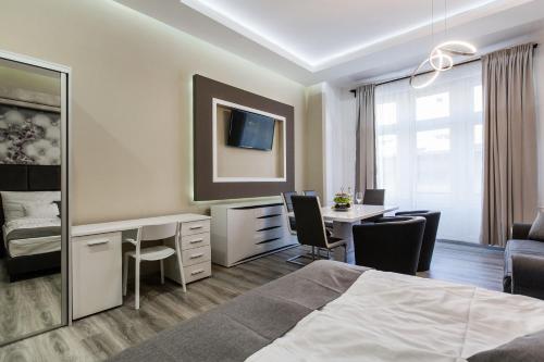a hotel room with a bed and a desk and a desk at A Golden Star Modern Luxury Apartments and Rooms Budapest in Budapest