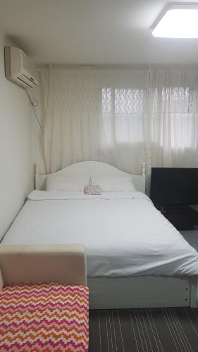 Cama o camas de una habitación en Blackgold Itaewon