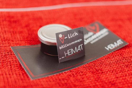 a tag on top of a red table at HEIMAT | Hotel & Boarding House in Mainburg