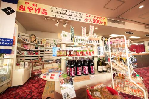 a store with a lot of bottles of wine at 吸う温泉 湯治の宿 竜王ラドン温泉 湯ーとぴあ in Kai