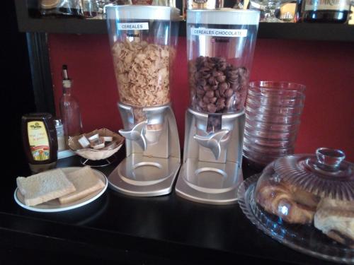 a table with two vases filled with nuts and bread at Hospedaxe Don Manuel in O Vicedo