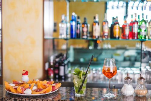 a table with a plate of food and a glass of wine at Hotel Firenze 2000 in Florence