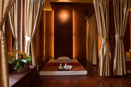 a room with a bed in a room with curtains at Salana Boutique Hotel in Vientiane