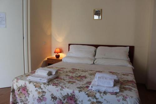 a bedroom with a bed with towels on it at AFFITTACAMERE La Tartaruga in Civitanova Marche
