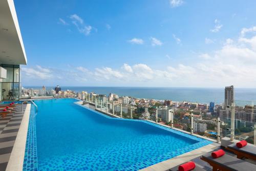 a large swimming pool on the roof of a building at Cinnamon Red Colombo in Colombo