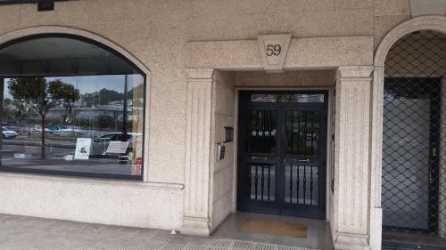 an entrance to a building with two glass doors at Macky's Pad in Pontevedra