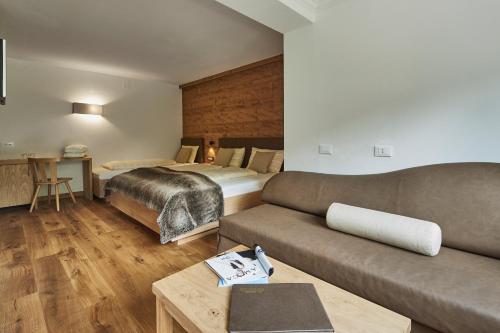 Ένα ή περισσότερα κρεβάτια σε δωμάτιο στο Hotel Cristallo - Wellness Mountain Living