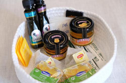 a basket filled with bottles of honey and cheese at LETHESHOME Apartments in Porto