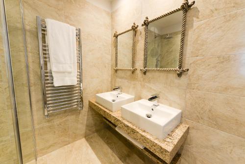 a bathroom with a sink and a mirror at Fence Gate Lodge in Burnley