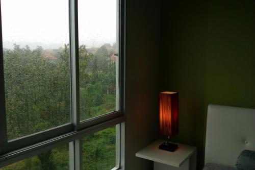 a room with two windows and a lamp on a table at D-condo mine in Kathu