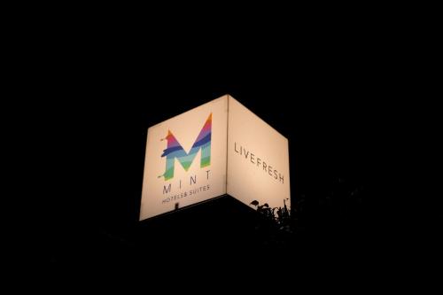 a lit up sign with a mnt logo on it at Elite Suites MINT Gomti Nagar in Lucknow