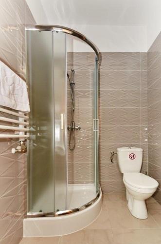 a bathroom with a shower and a toilet in it at Pokoje U Filipa in Krakow