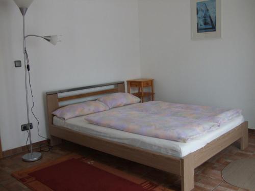 a bedroom with a bed in a room with a lamp at A2-Vermietung in Peine