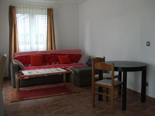 a living room with a red couch and a table at A2-Vermietung in Peine