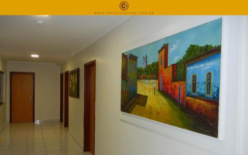 a painting hanging on a wall in a hallway at Hotel Castro in Palmas