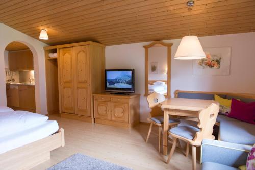 a living room with a dining table and a bedroom at Haus Braunarl in Lech am Arlberg