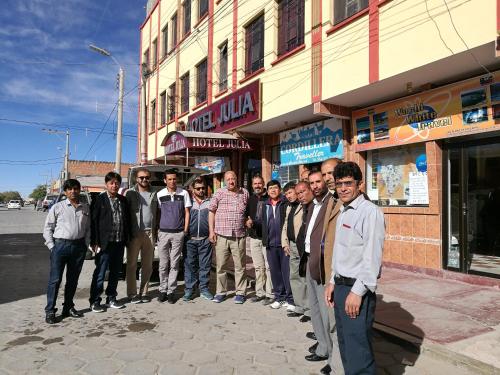 a group of men standing in front of a building at Hotel Julia in Uyuni