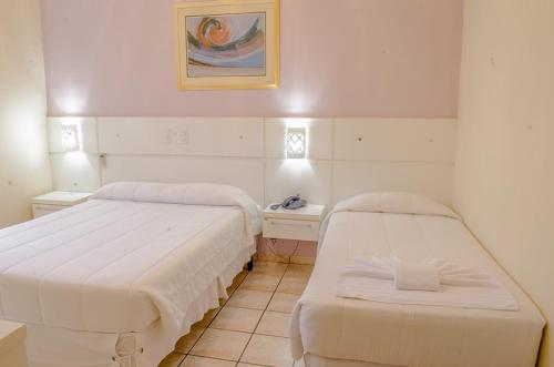 Кровать или кровати в номере 27 Praia Hotel - Frente Mar