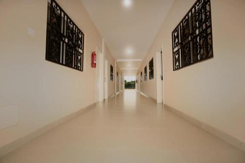 an empty hallway with white walls and white floors at Regal Apartments in Kololi