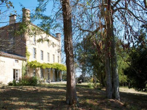 a large white house with trees in front of it at B&B Château de Fajac la Selve in Pech-Luna
