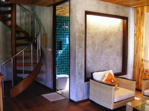 a bathroom with a spiral staircase and a toilet at Baan Banyan Villa, wood house short walk to Mae Nam beach in Mae Nam