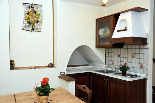 a kitchen with a wooden table and a sink at Rupe Antica in Artena