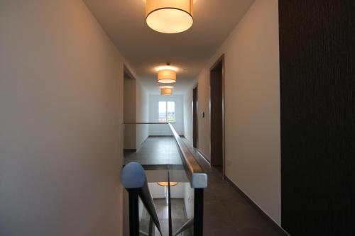 a hallway with a wooden table and a ceiling at BA Hotel by WMM Hotels in Babenhausen