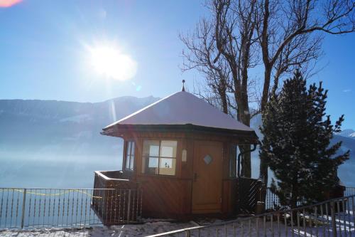 a small cabin with a snow covered roof at Panoramapension Platzer in Kolbnitz