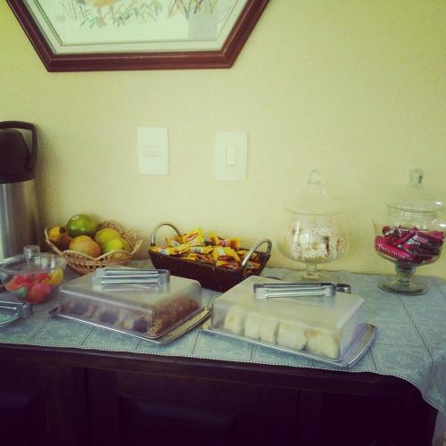 two trays of food sitting on a counter with fruit at Pousada Hippocampus in Juquei